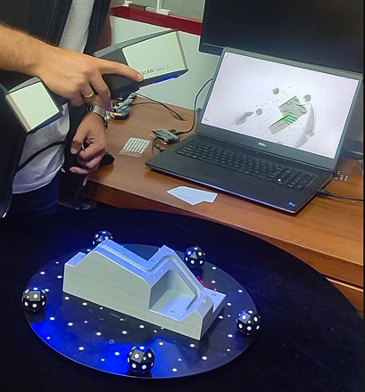 T-SCAN hawk 2 scanning grey plastic part on a rotation table