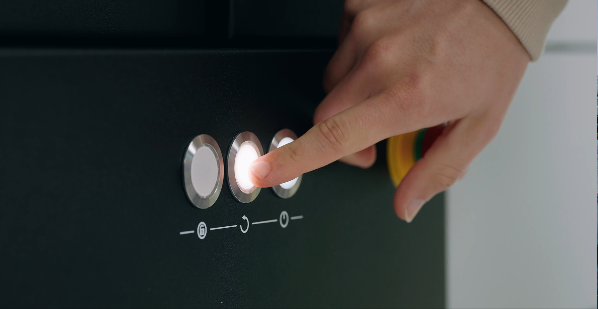 A hand is pressing a button on a CT scanner