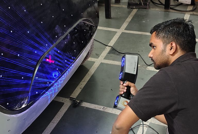A man using handheld 3d scanner to scan an EV